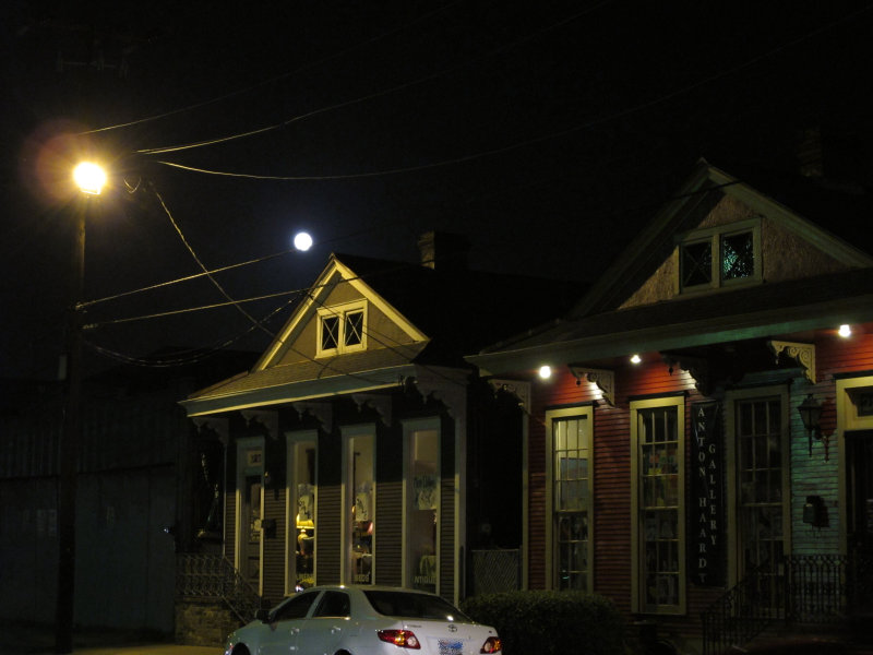 House faces along Magazine Street, at night.