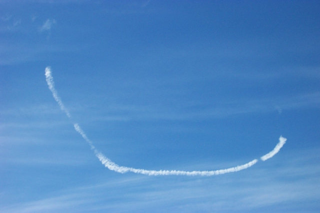 An airplane trail that resembles a smile.