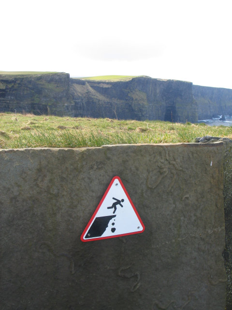 An edge-of-cliff warning sign at the Cliffs of Moher, in Ireland.
