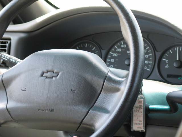 A steering wheel of a Chevrolet Venture minivan.