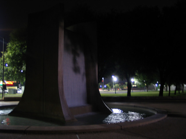 Blurry picture of the fountain at the Waco Hilton, at night.