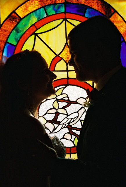 Wife, groom, stained glass background.