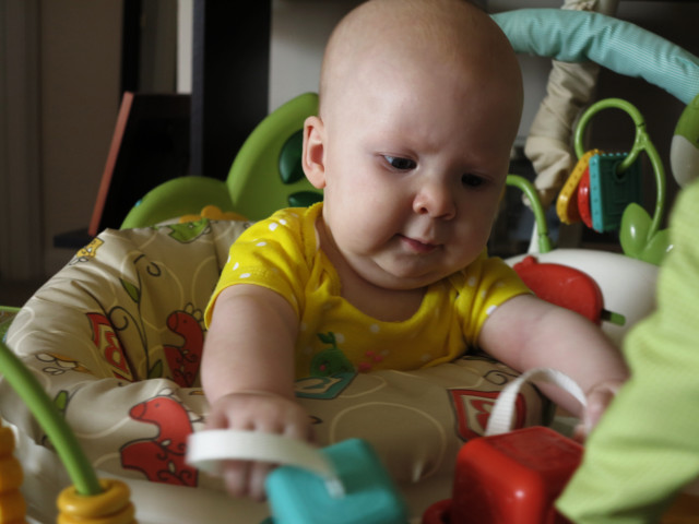 Infant in a bounce-thing that they sit in and bounce in.